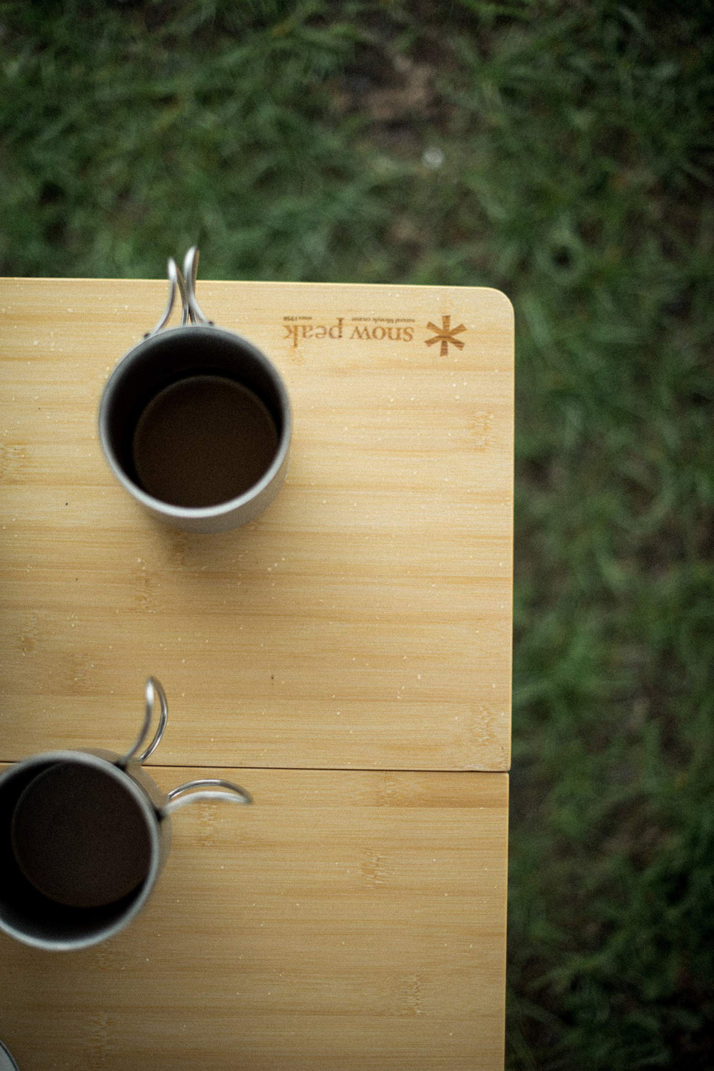 Snow Peak double-wall mug in outdoor use on a rugged trail