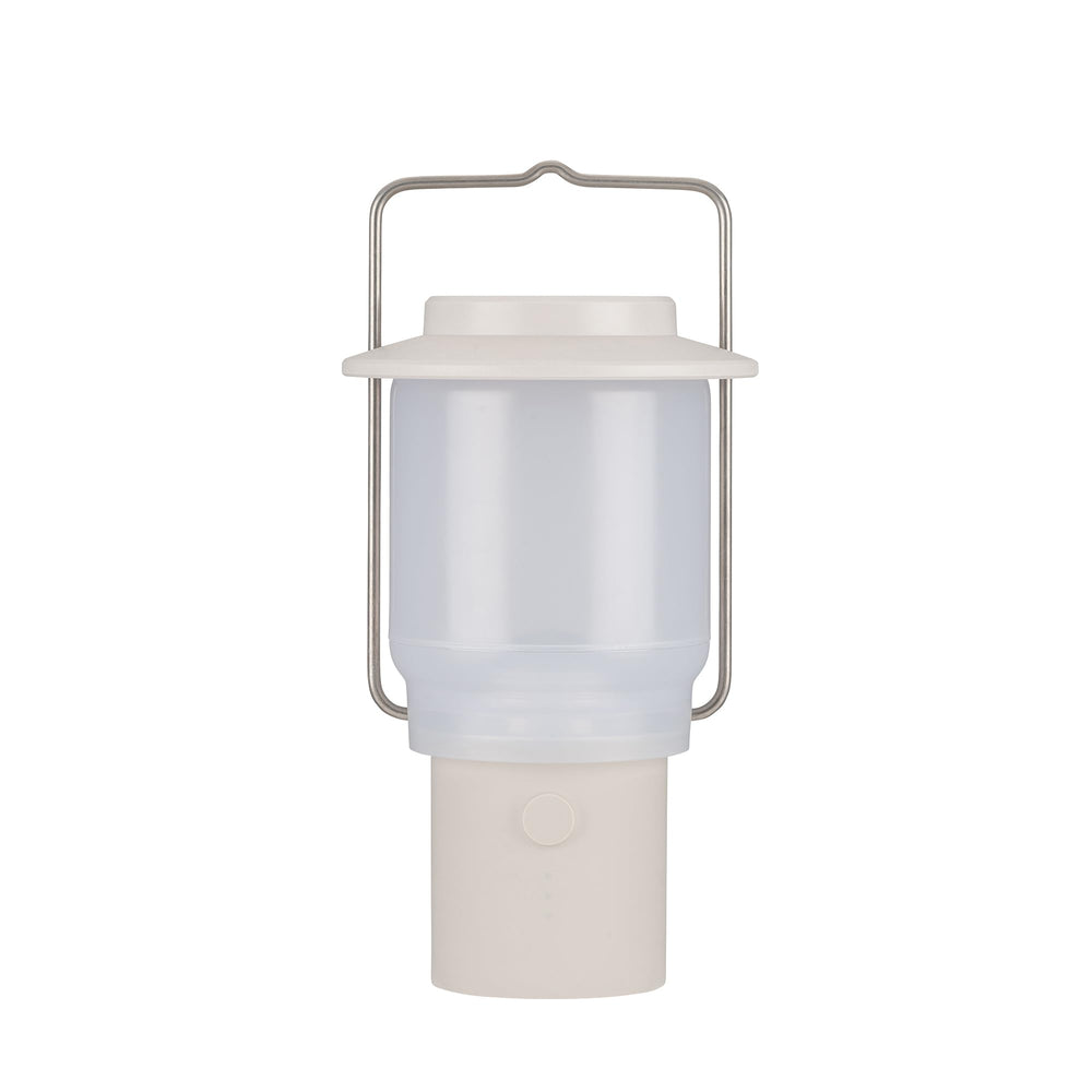 Snow Peak Mini Hozuki battery-powered lantern emitting warm ambient light at a campsite
