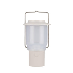 Snow Peak Mini Hozuki battery-powered lantern emitting warm ambient light at a campsite