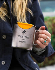 Snow Peak TI600 mug in nature setting highlights durable titanium