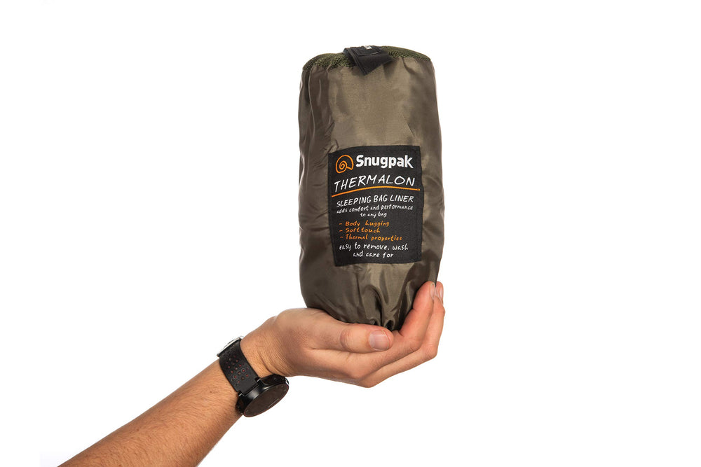 Snugpak Thermalon liner rolled in compression sack for travel and compact packing.