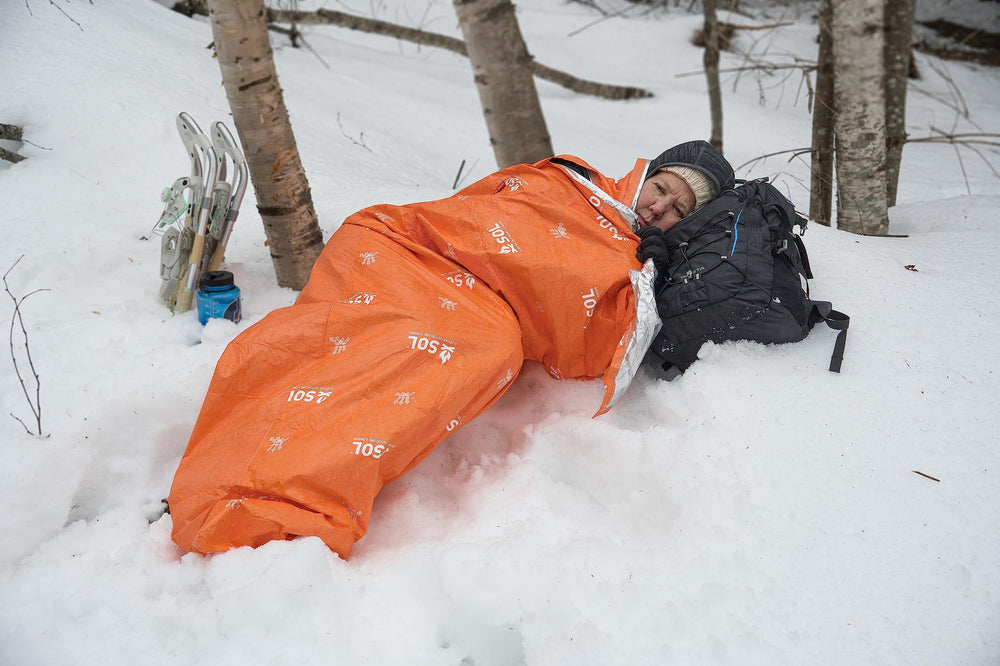 The SOL Escape Lite Bivvy orange color makes it easy to spot in gear.
