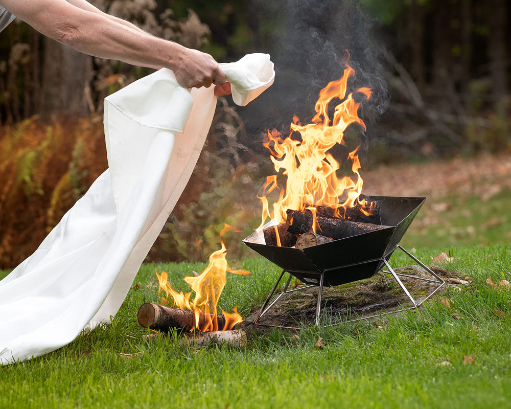 S.O.L. fire blanket fully deployed to quickly smother a cooking fire on grill.