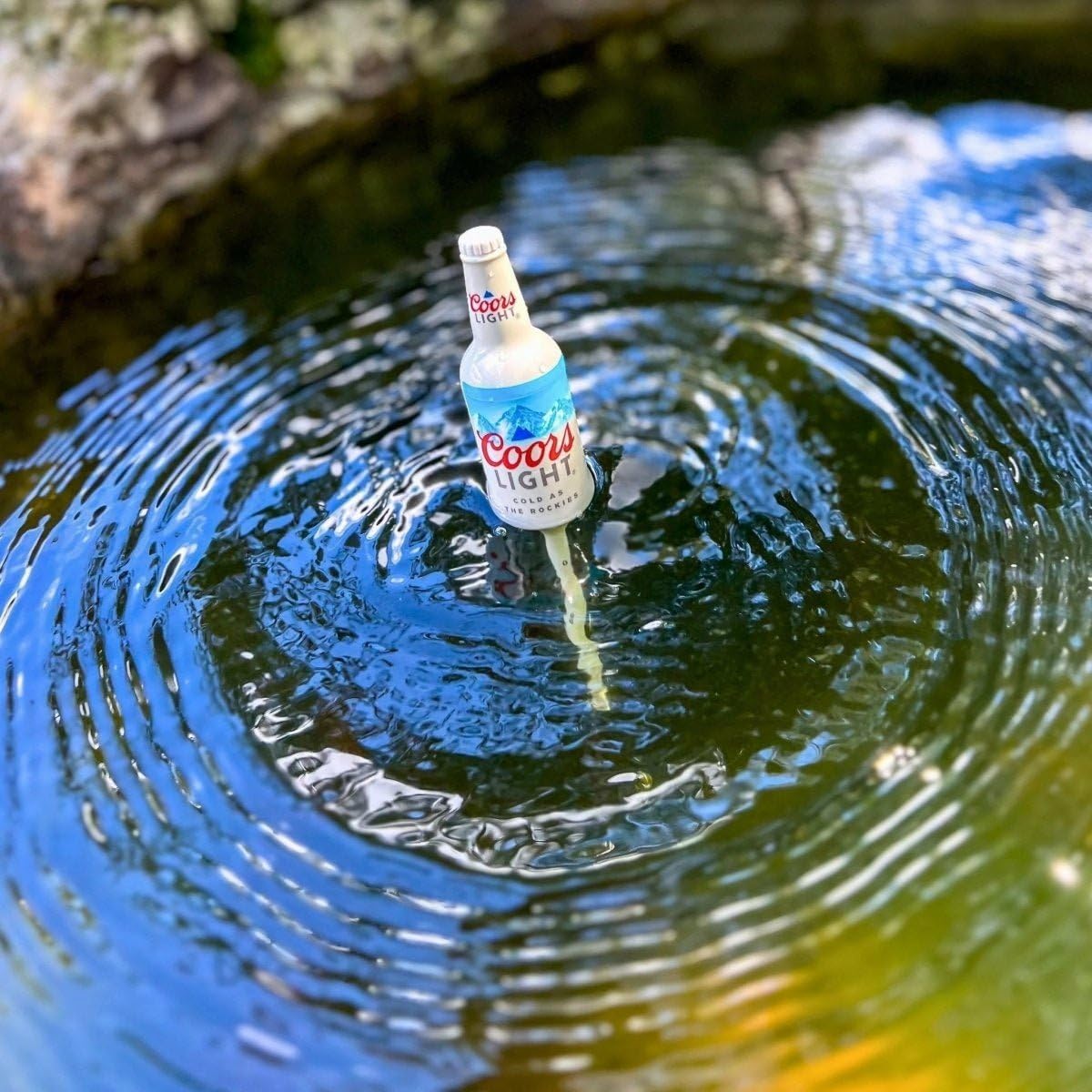 Coors Light bottle bobbers on a fishing rod setup providing a playful yet practical rig