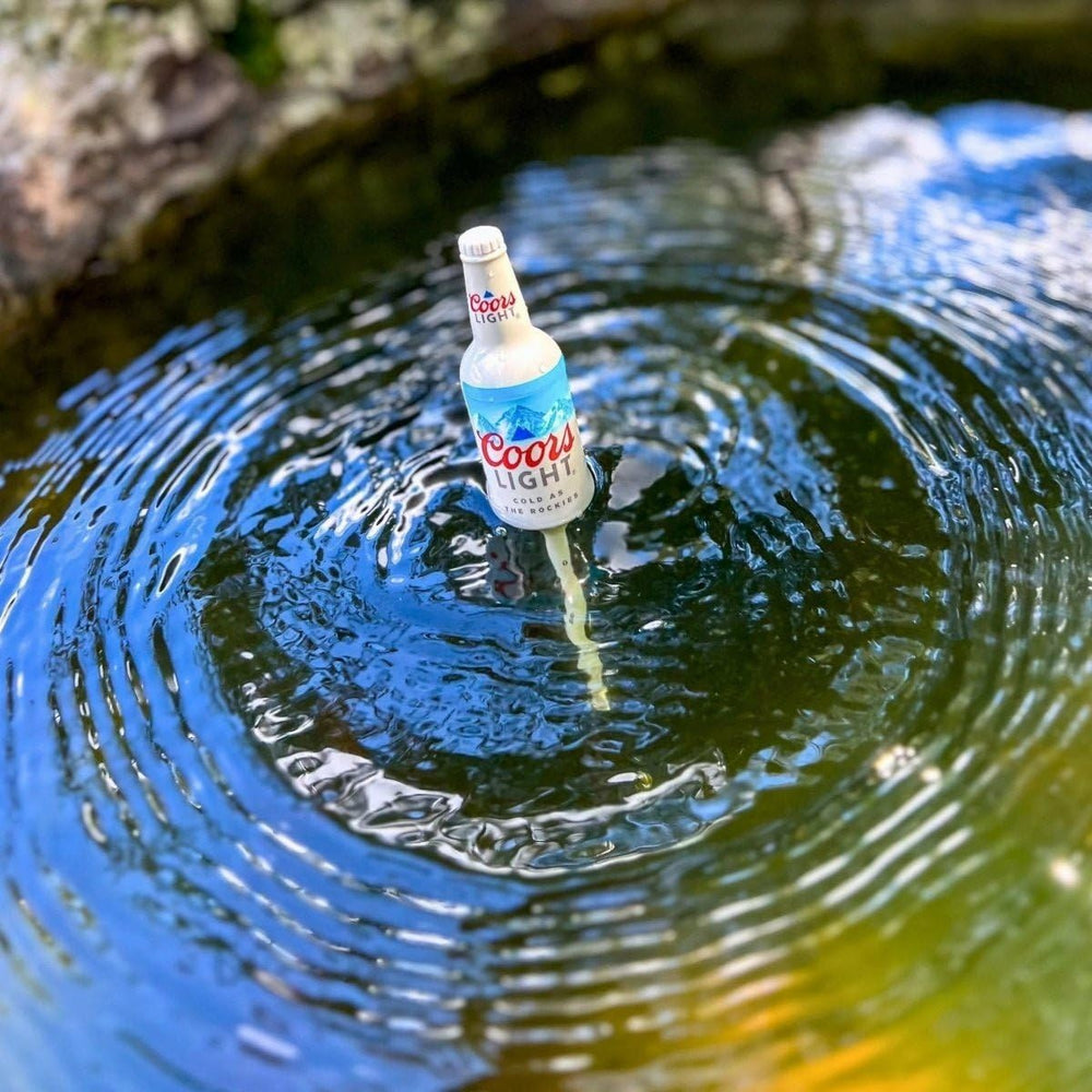 Coors Light bottle bobbers on a fishing rod setup providing a playful yet practical rig