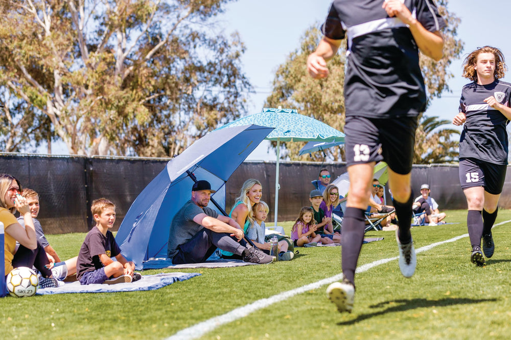 Sport-Brella Ultra privacy panel shielding sun and wind during viewing