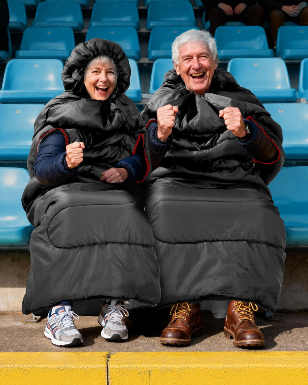 Sportneer wearable sleeping bag hood-drawcord demonstrates snug warmth on chilly bleachers.