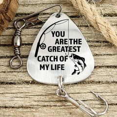Close-up of engraving on stainless steel fishing lure