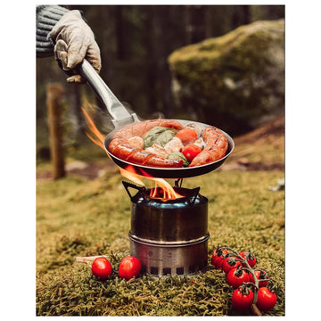 Stabilotherm Hunter Pan over open fire enables versatile outdoor frying.