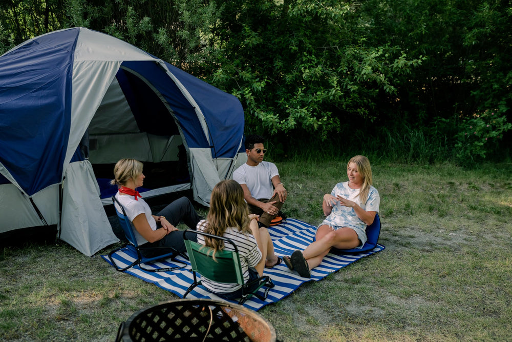 Stansport foldable ground mat shows handle and pockets for storage.