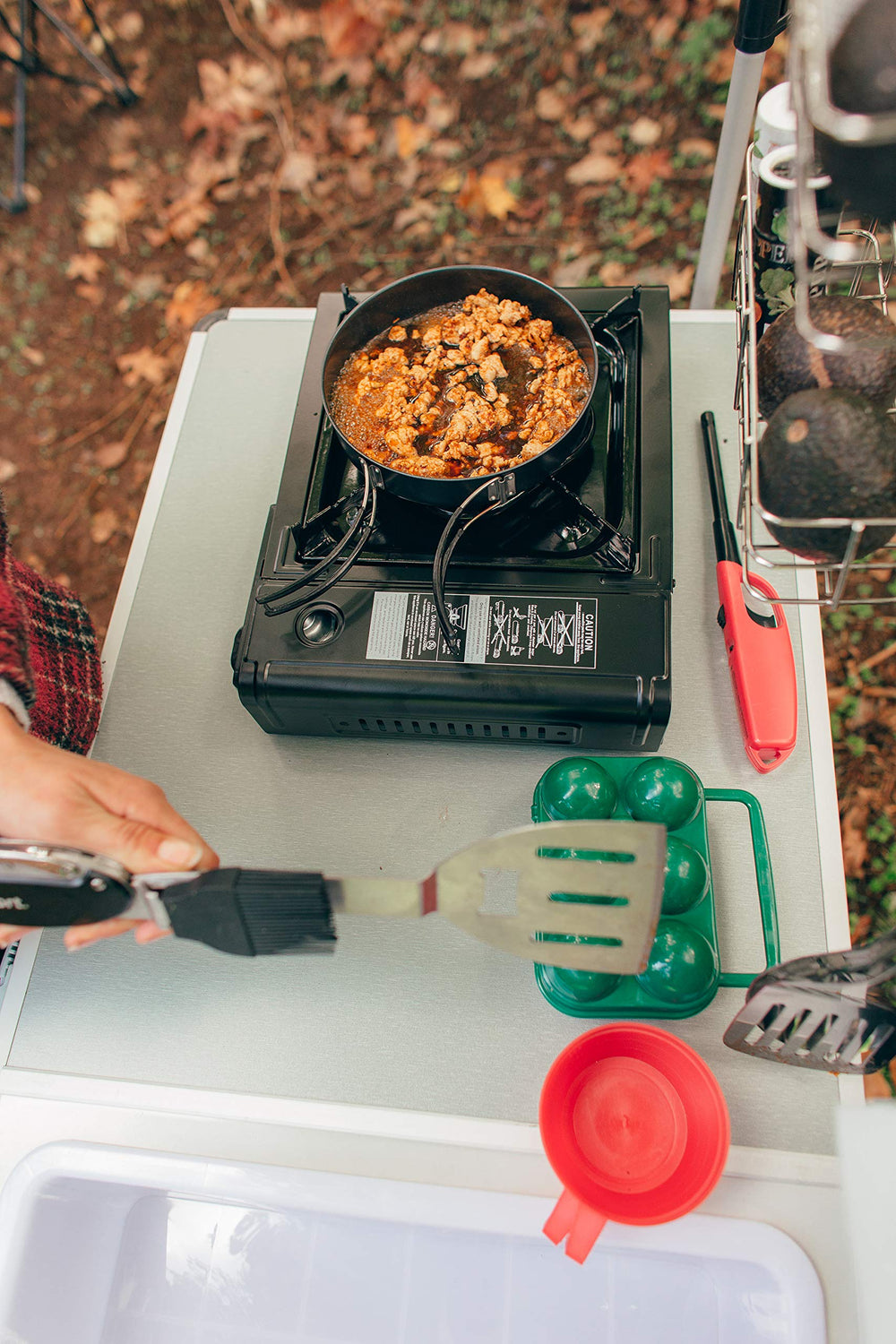 Stansport stove cooking with 8000 BTU power for quick meals.