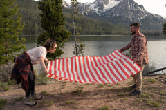 Stansport Tatami Ground Mat red, picnic setup for outdoor meals and shade breaks.