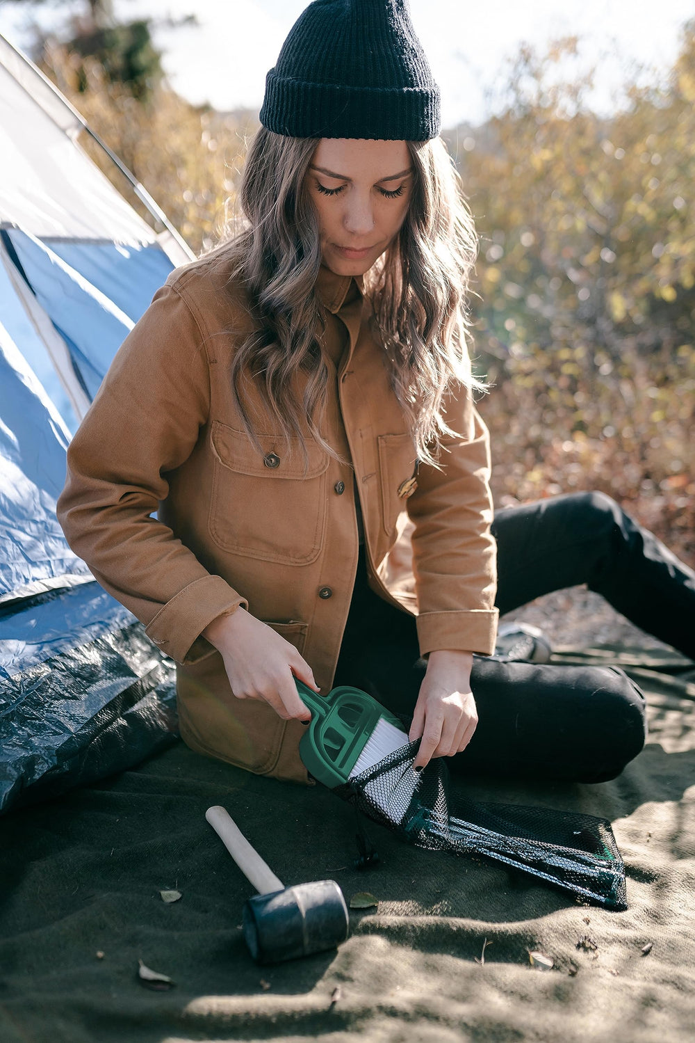 Stansport Tent Essentials Kit T-top stakes in ground for stability.