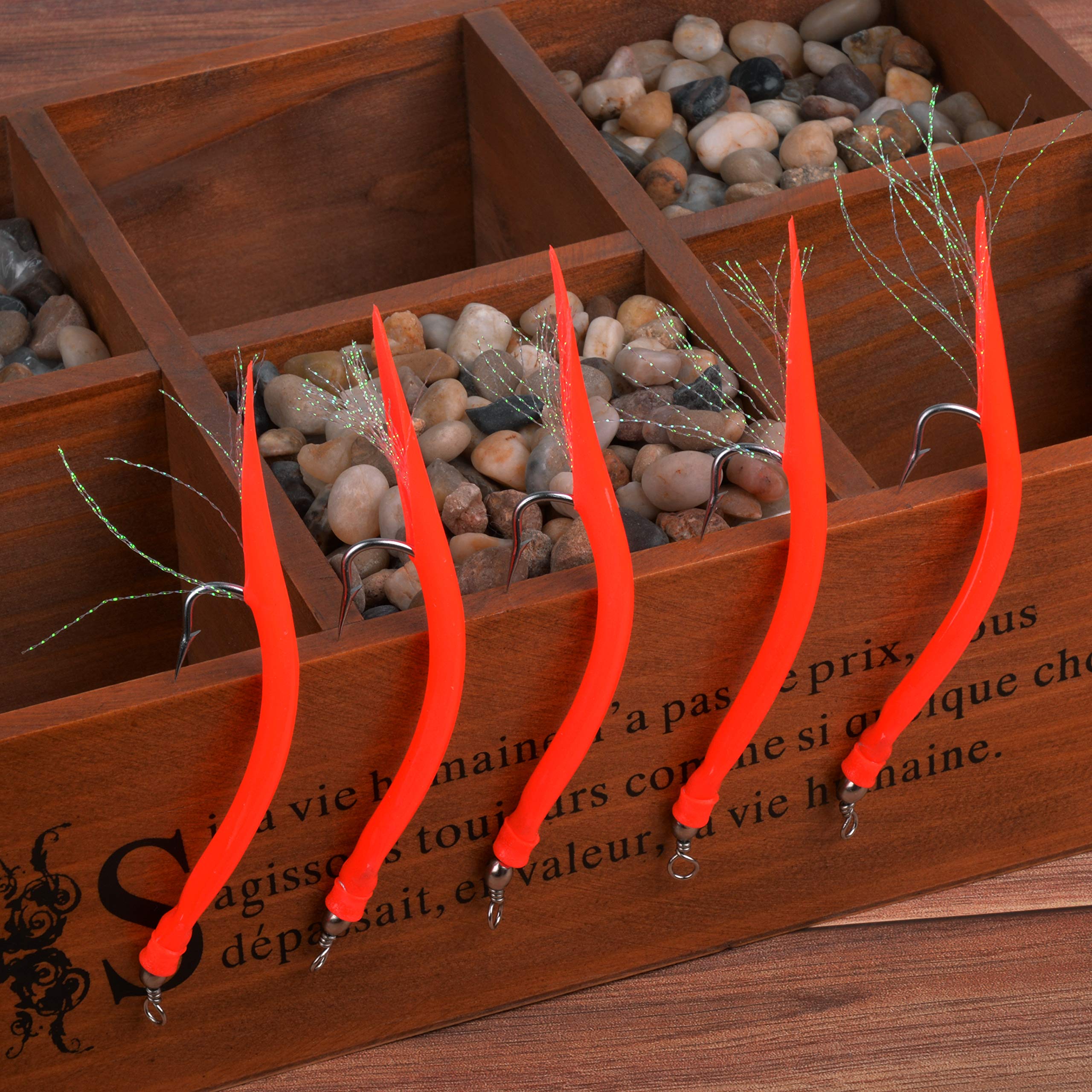 Red striped bass tube lure ready for saltwater fishing