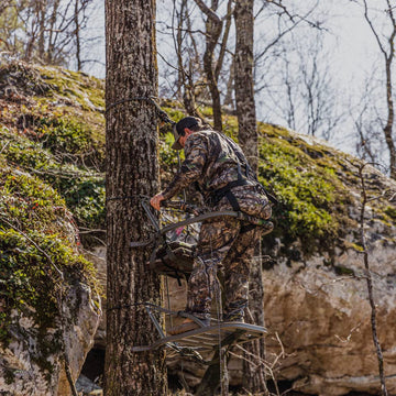 Goliath SD Mossy Oak camouflage blends with woodland surroundings.