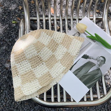 Close-up of checkered print on straw sun hat