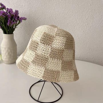 Beach-ready woman wearing beige checkered sun hat