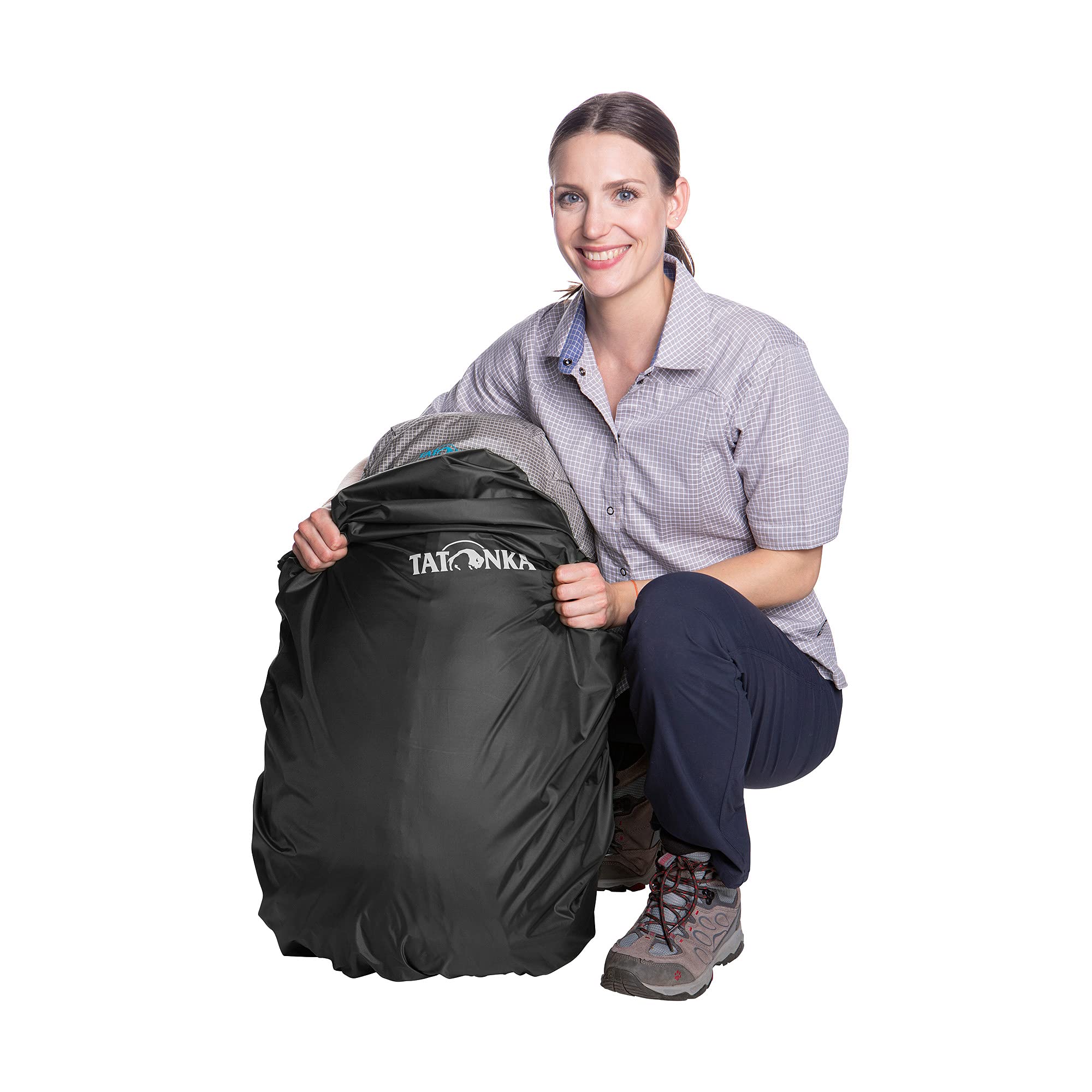 Tatonka black rain cover on a backpack during a light shower.