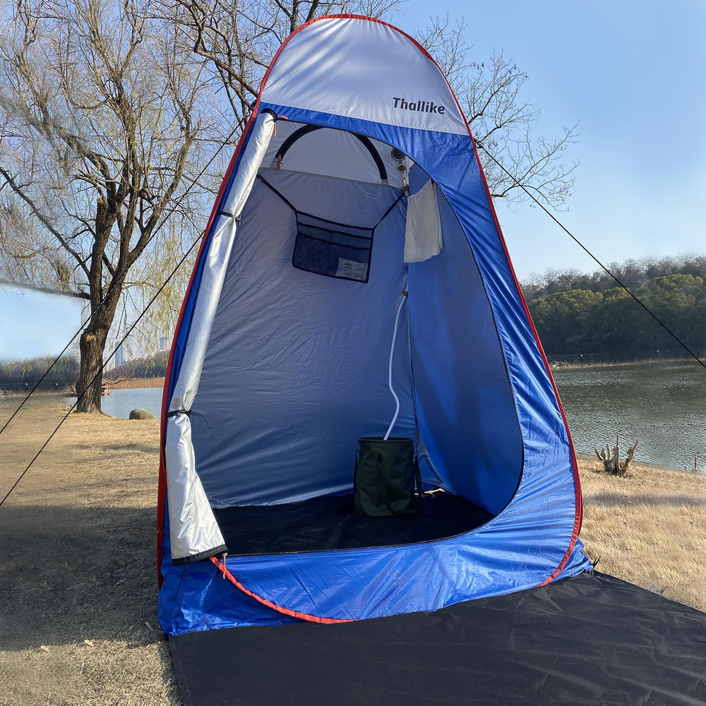Thallike camping shower tent with extended floor mat keeps campsite dry.