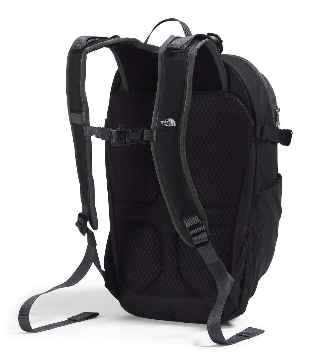 The North Face Basin 15L external-zip-pocket demonstrates fast-access storage during hikes.