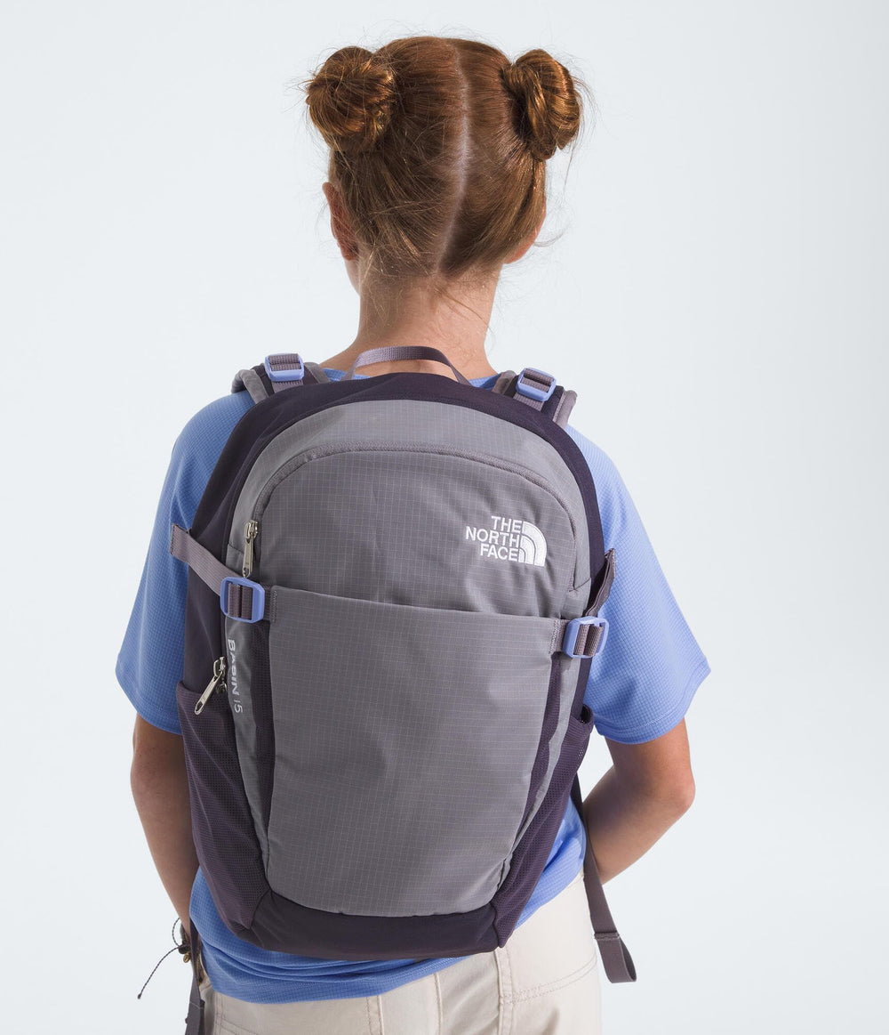 The North Face Basin 15L trekking pole attachment keeps poles secure on rugged terrain.