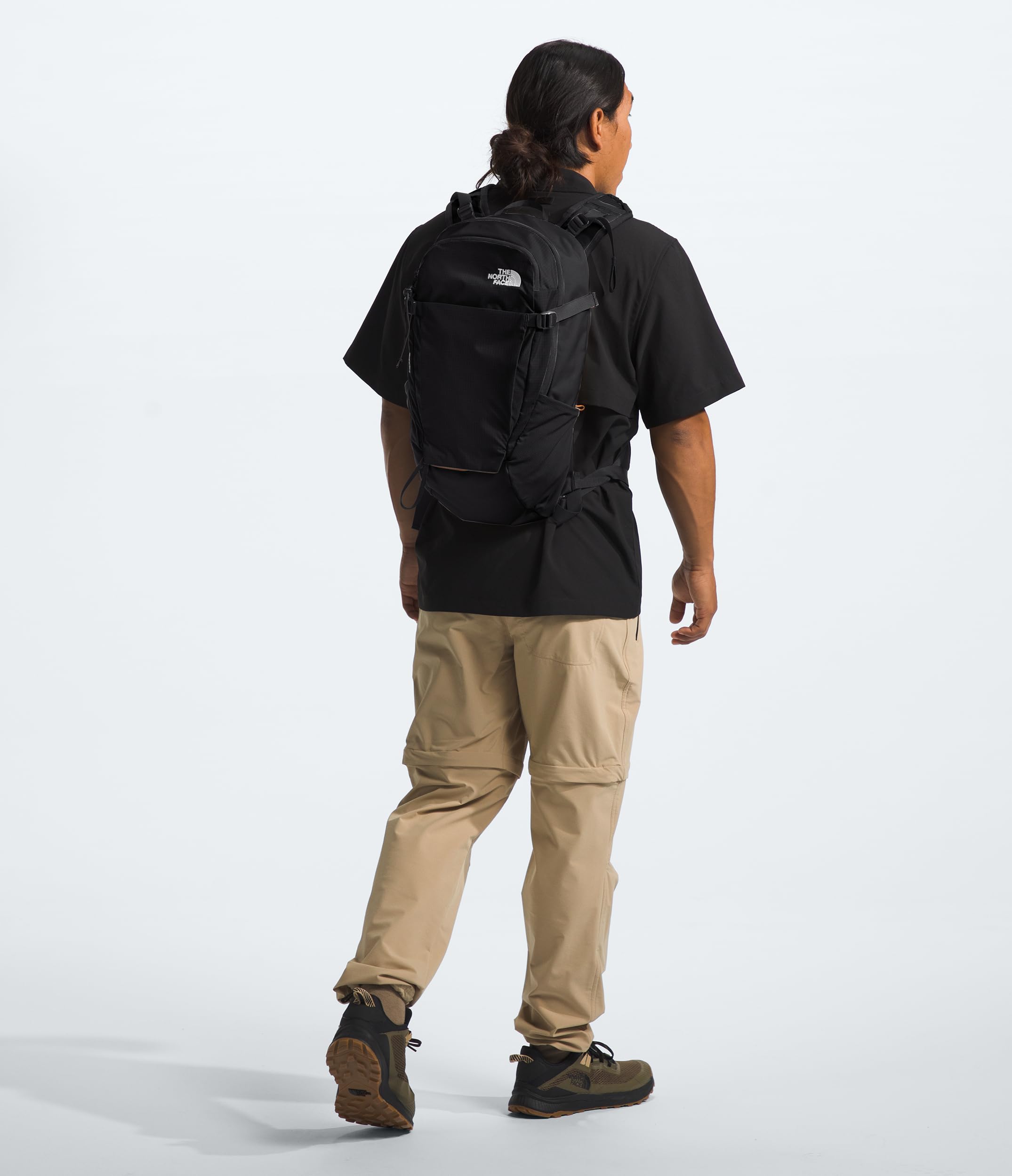The North Face Basin 24L daypack side pocket view showing easy-access bottle stashes for hydration on the go.