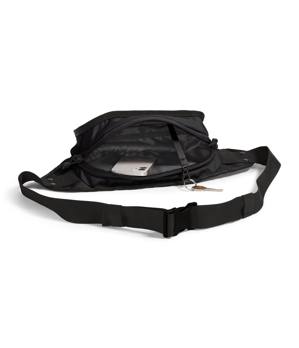 The North Face Explore Hip Pack fabric closeup reveals water-repellent finish and rugged texture