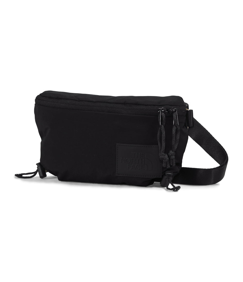The North Face Never Stop Lumbar front view highlights compact city carry.
