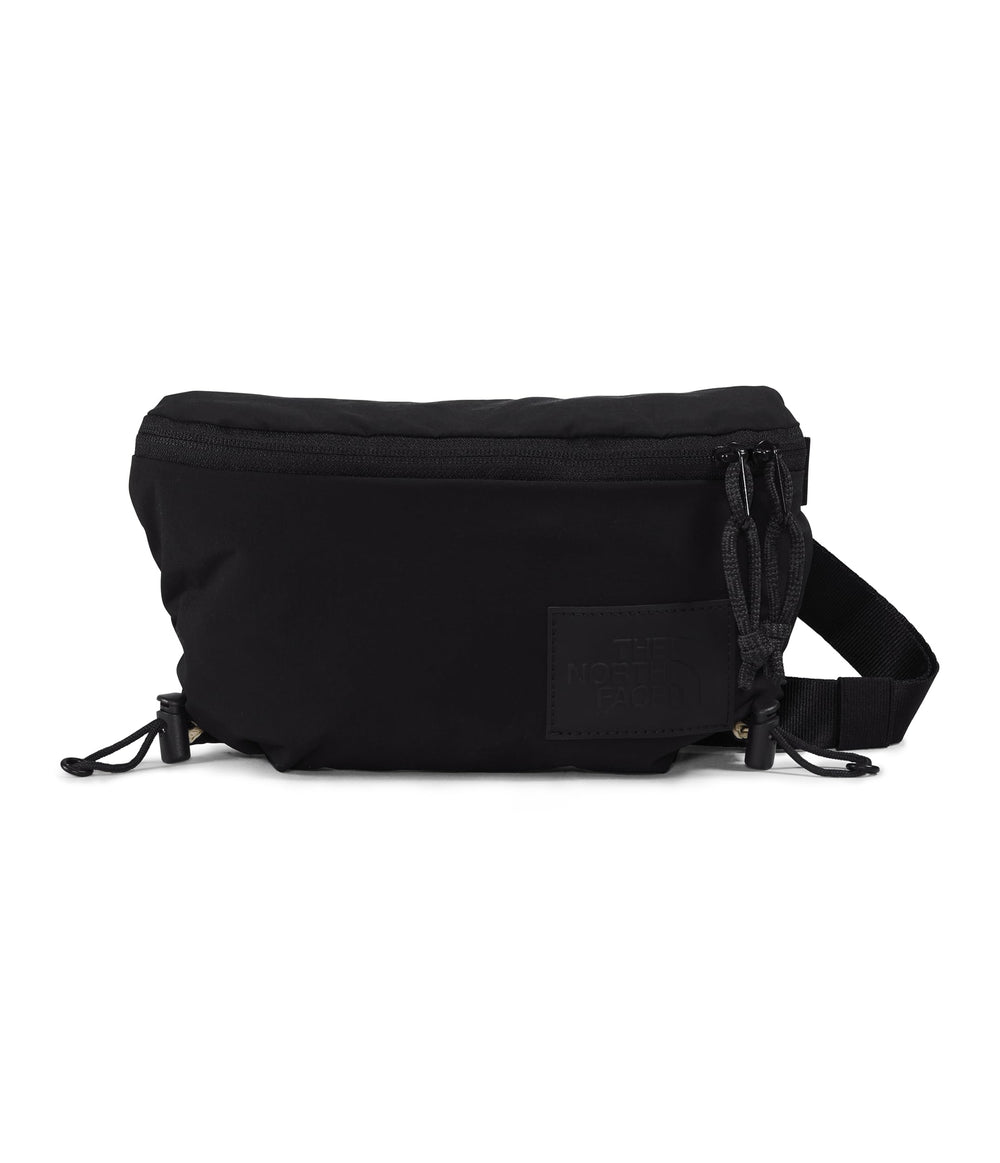 The North Face Never Stop Lumbar top-zip closure for quick access.