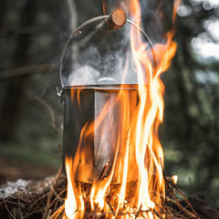 The Pathfinder School 64oz bush pot with lid on highlights secure outdoor cooking.