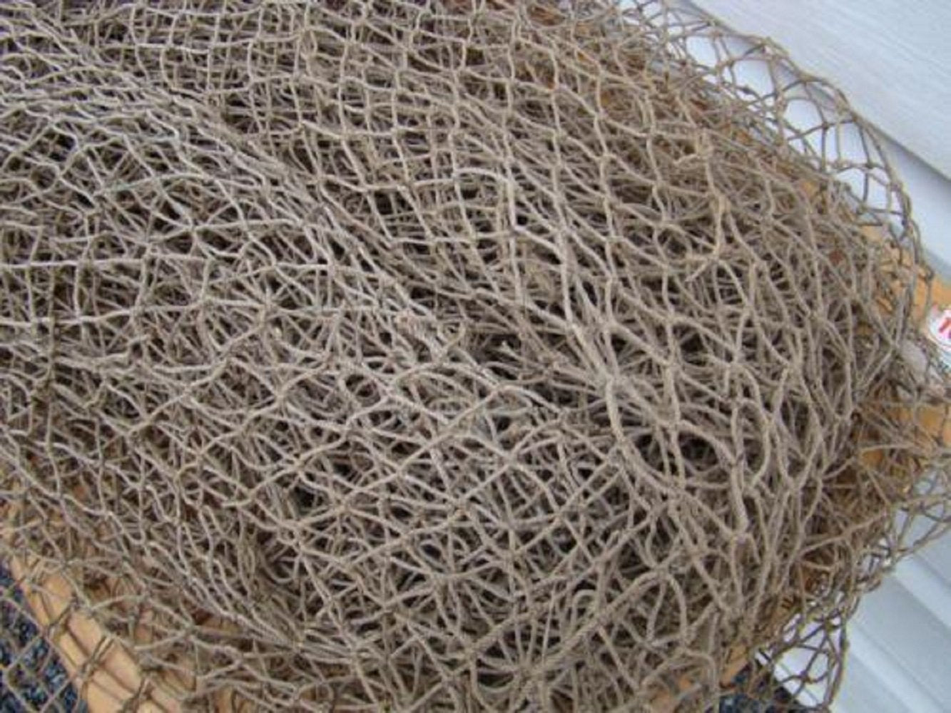 The Shell Connection tan/grey fish netting, 5' x 10', lightweight and durable for versatile fishing use.