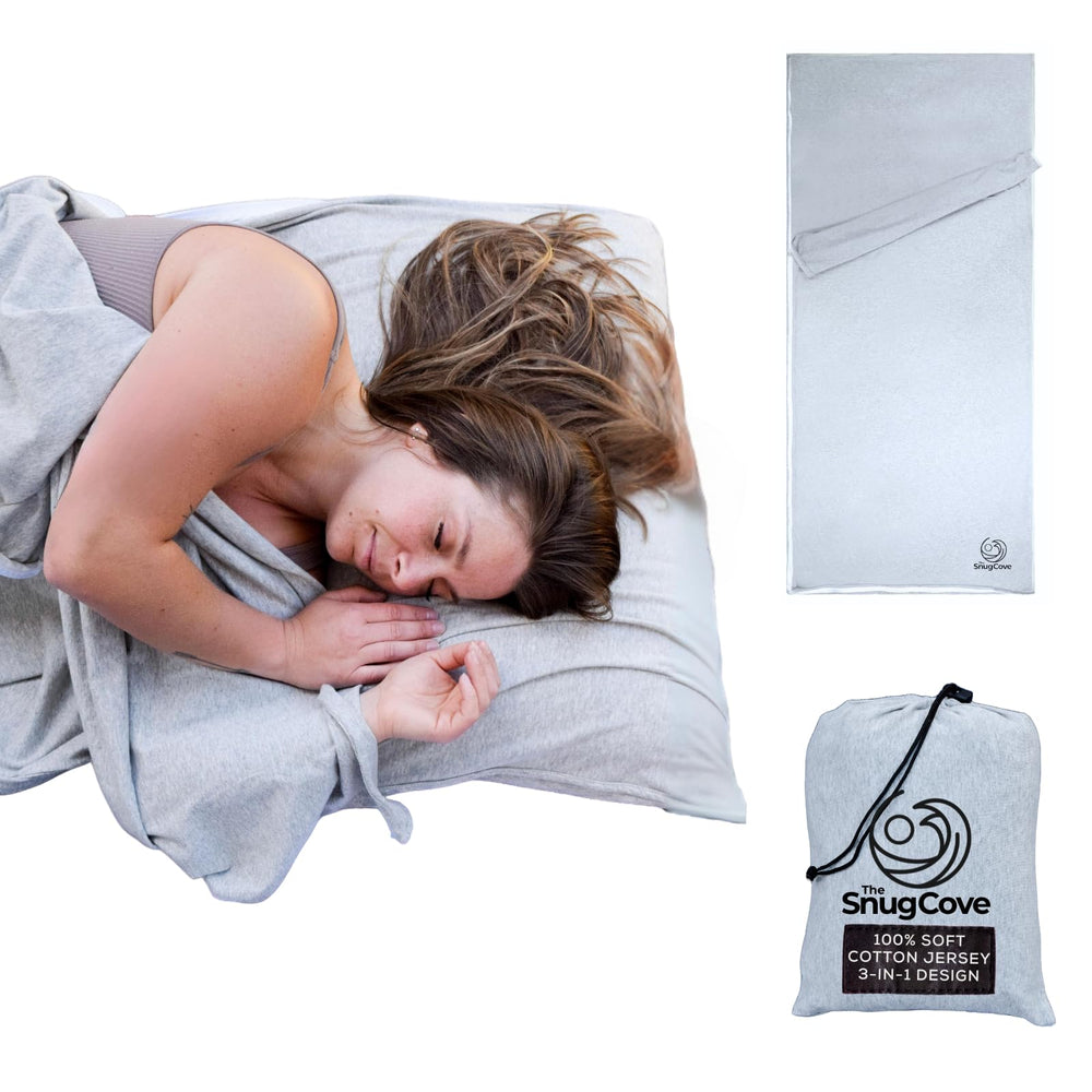 The Snug Cove soft cotton sleeping bag liner in a compact travel pouch for hotel stays.