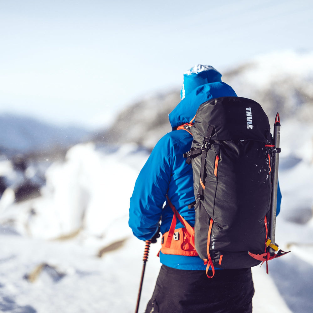Thule Alltrail rain cover stored for storm-ready protection on treks.