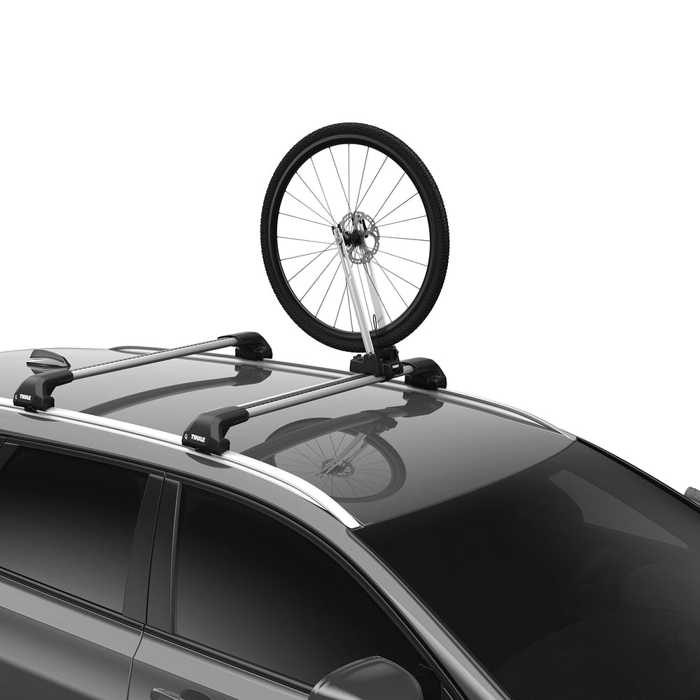Thule Front Wheel Holder mounted on a roof rack securing a wheel for transport.