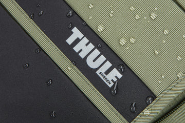 Thule Paramount Commuter Backpack 18L olive roll-top closure in action
