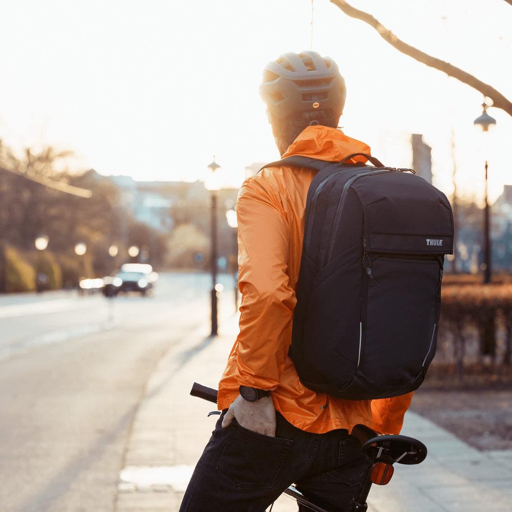 Thule Paramount Commuter Backpack front expansion pocket holds helmet or shoes.