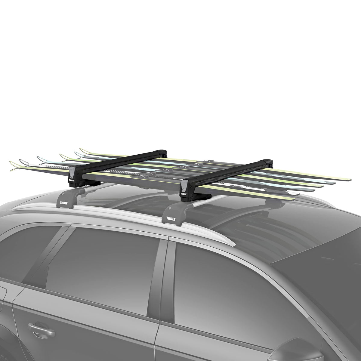 Thule SnowPack Large loading skis on roof, secure and ready for a winter trip.