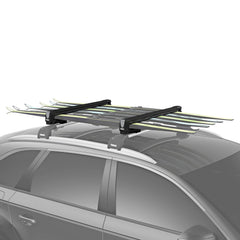 Thule SnowPack Large loading skis on roof, secure and ready for a winter trip.