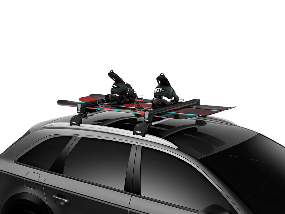 Thule SnowPack Large securing snowboards for safe rooftop transport.