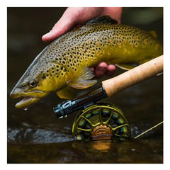 Matte olive finish fly fishing reel attached to a rod