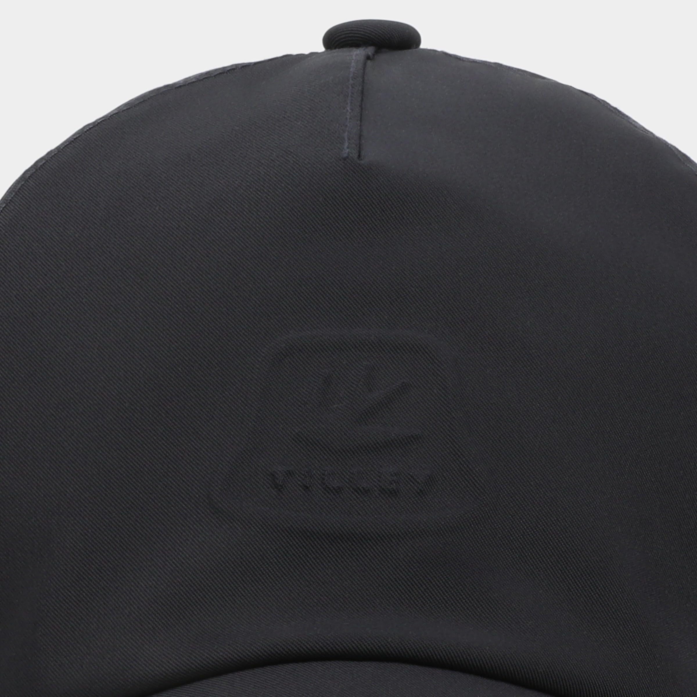 Tilley travel cap navy in use during outdoor activity with ventilation.