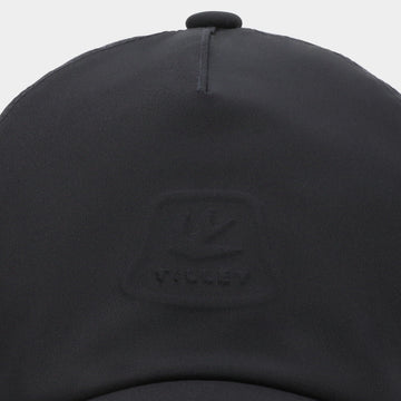 Tilley travel cap navy in use during outdoor activity with ventilation.