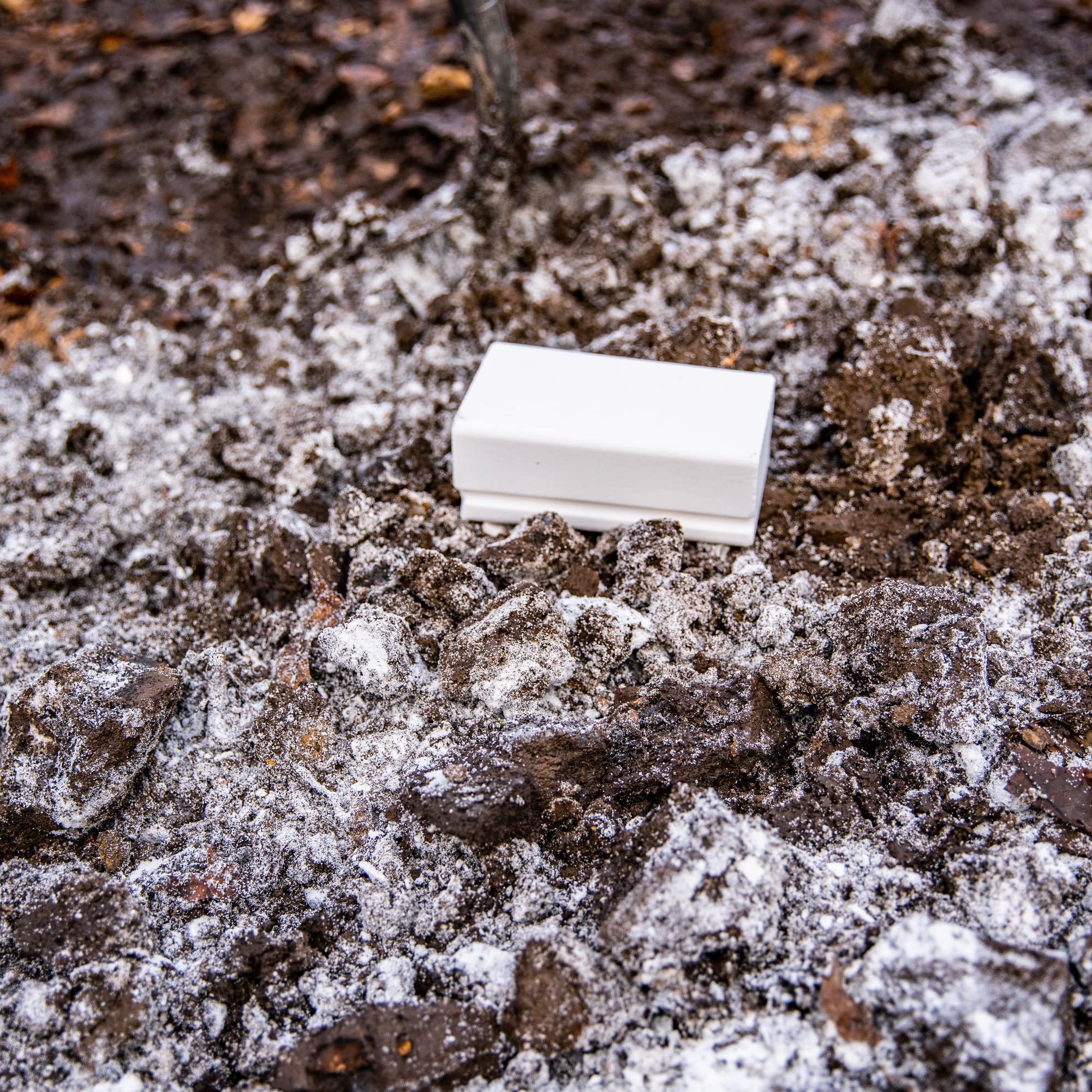 Time-release mineral block saturating soil when it rains