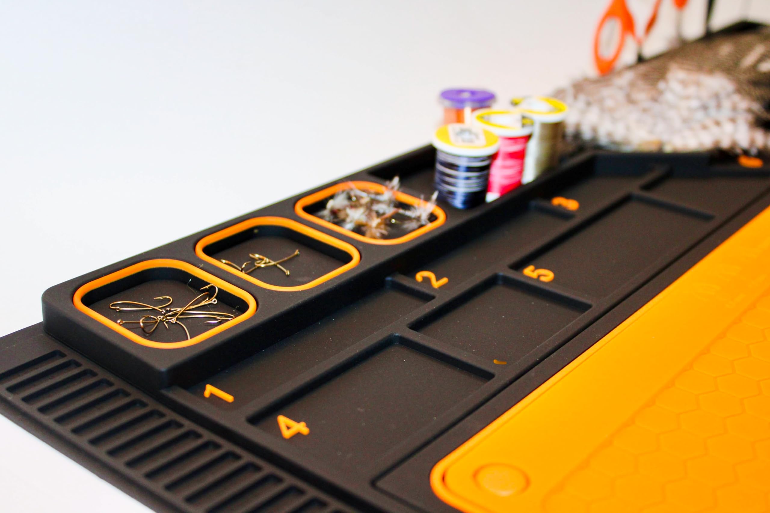 Tinfish Tackle Co storage holes neatly hold scissors and bobbins.