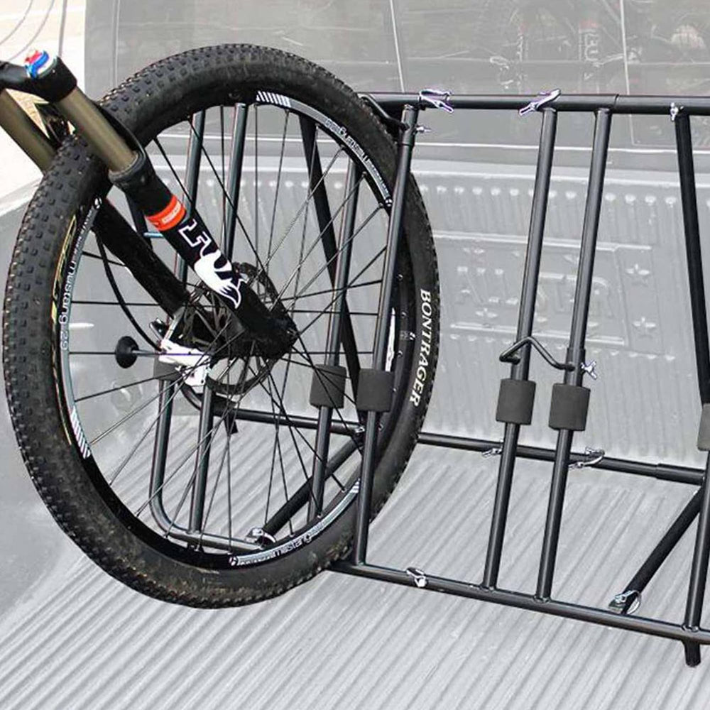 Bikes secured on Titan Ramps rack against road vibrations during travel.