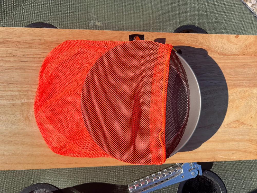 TOAKS Titanium D6.5 plate stacked with frying pan for compact storage.