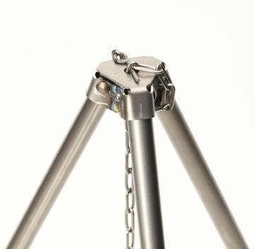 TOAKS titanium tripod over-fire use for hanging cookware and bottles.