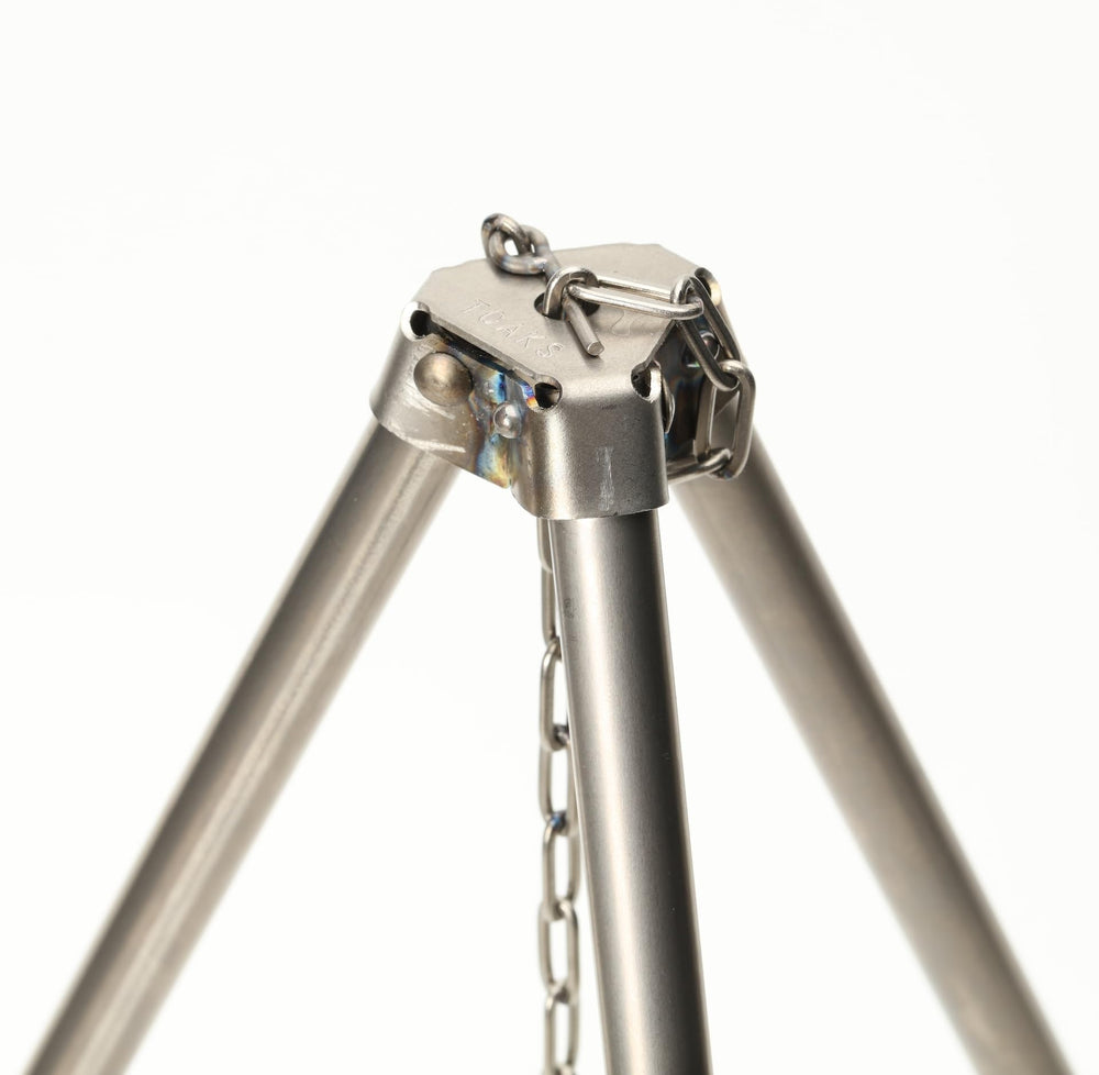TOAKS titanium tripod over-fire use for hanging cookware and bottles.