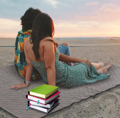 Tranqun outdoor blanket open on a beach scene demonstrates windproof comfort