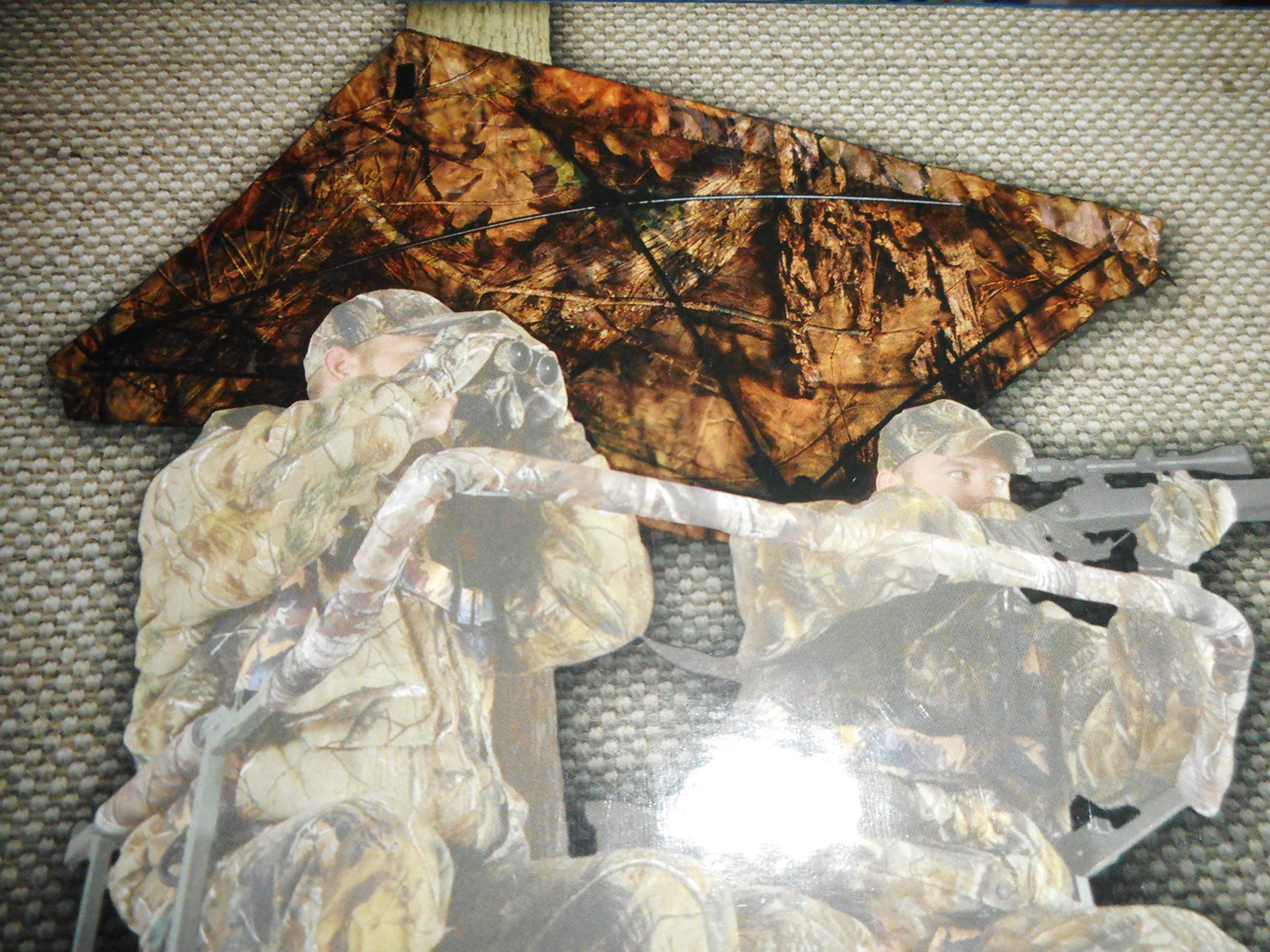 Close-up of hub-style umbrella protecting hunter from rain and sun